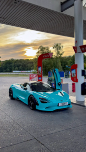 McLaren 750S Spider in Tokyo Cyan parked at a petrol station